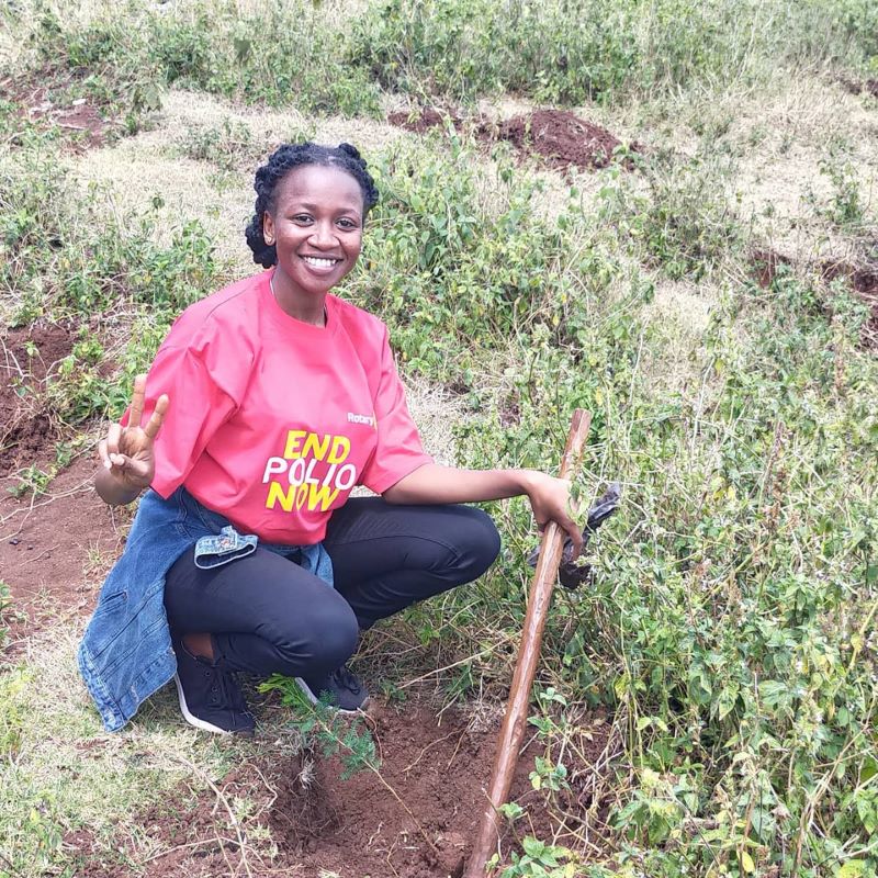 Rotarian Anita Bosibori from RC Nairobi Karengata poses after planting a tree